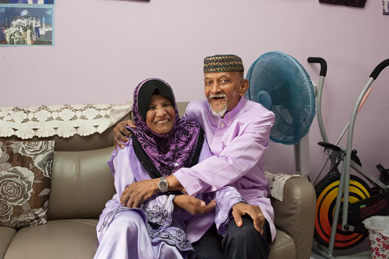 Loving portrait of elderly couple living in rental hdb flat in singapore, photographed by Kelvin Lim